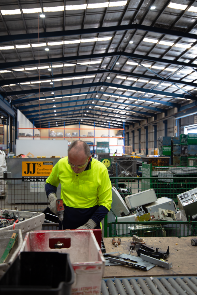 A man dismantling an electronic good